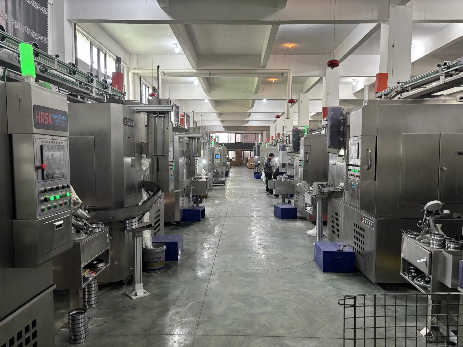 Rows of CNC bearing ring grinding machines along the aisle of the FULI workshop in Linqing