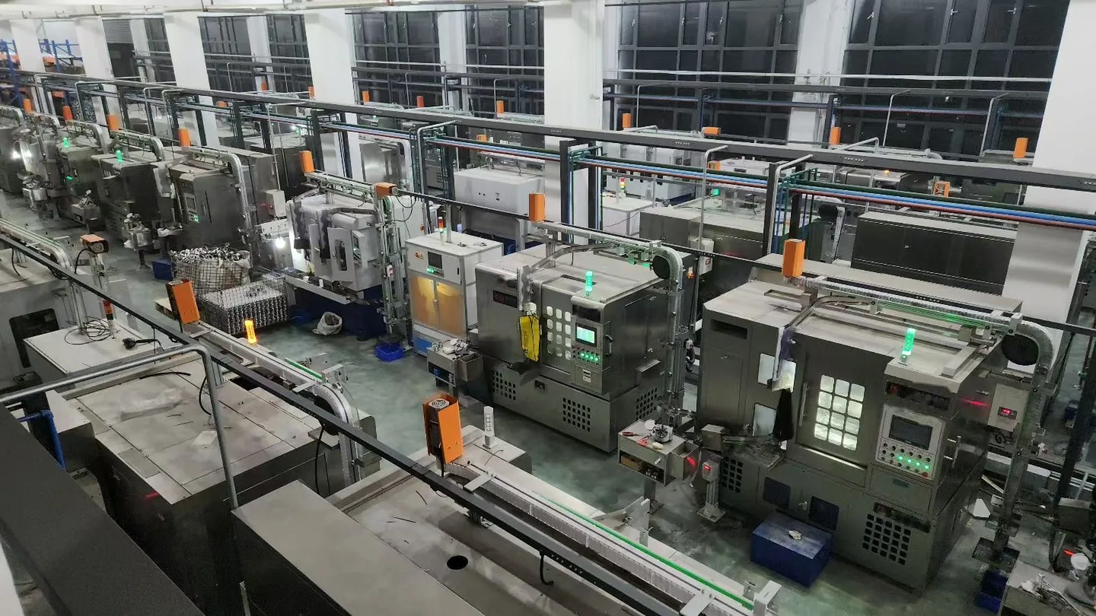 A long aisle of automated bearing grinding machines in a factory hall